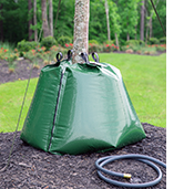 Treegator® Original Double Bag Setup with curled garden hose on mulch